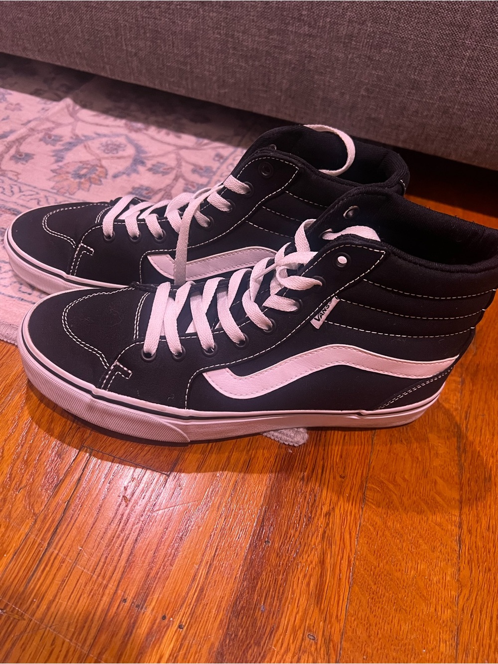 Vans womenβs Sk8-Hi High Top Sneakers in Black and White